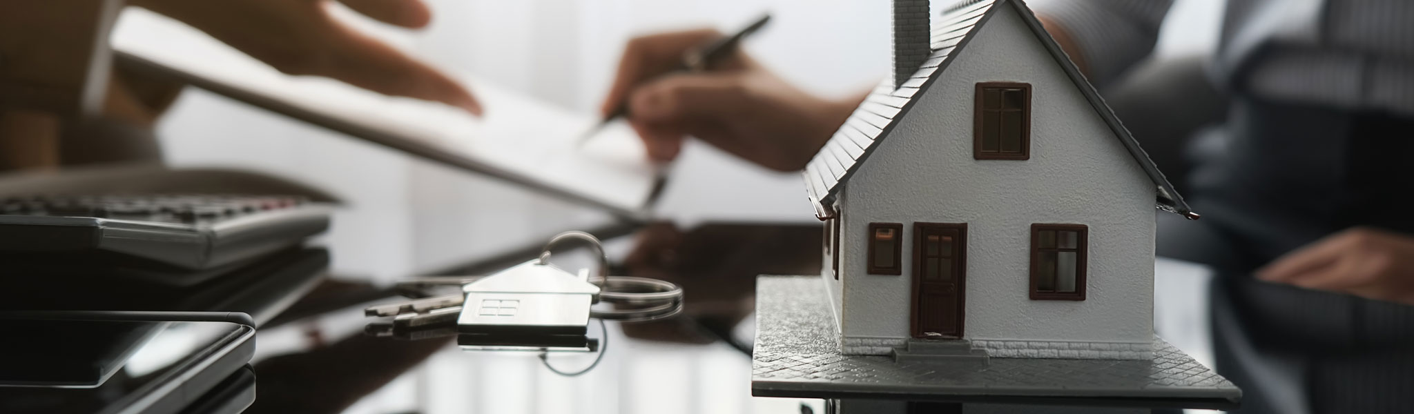 Real estate agent and customer signing contract to buy house